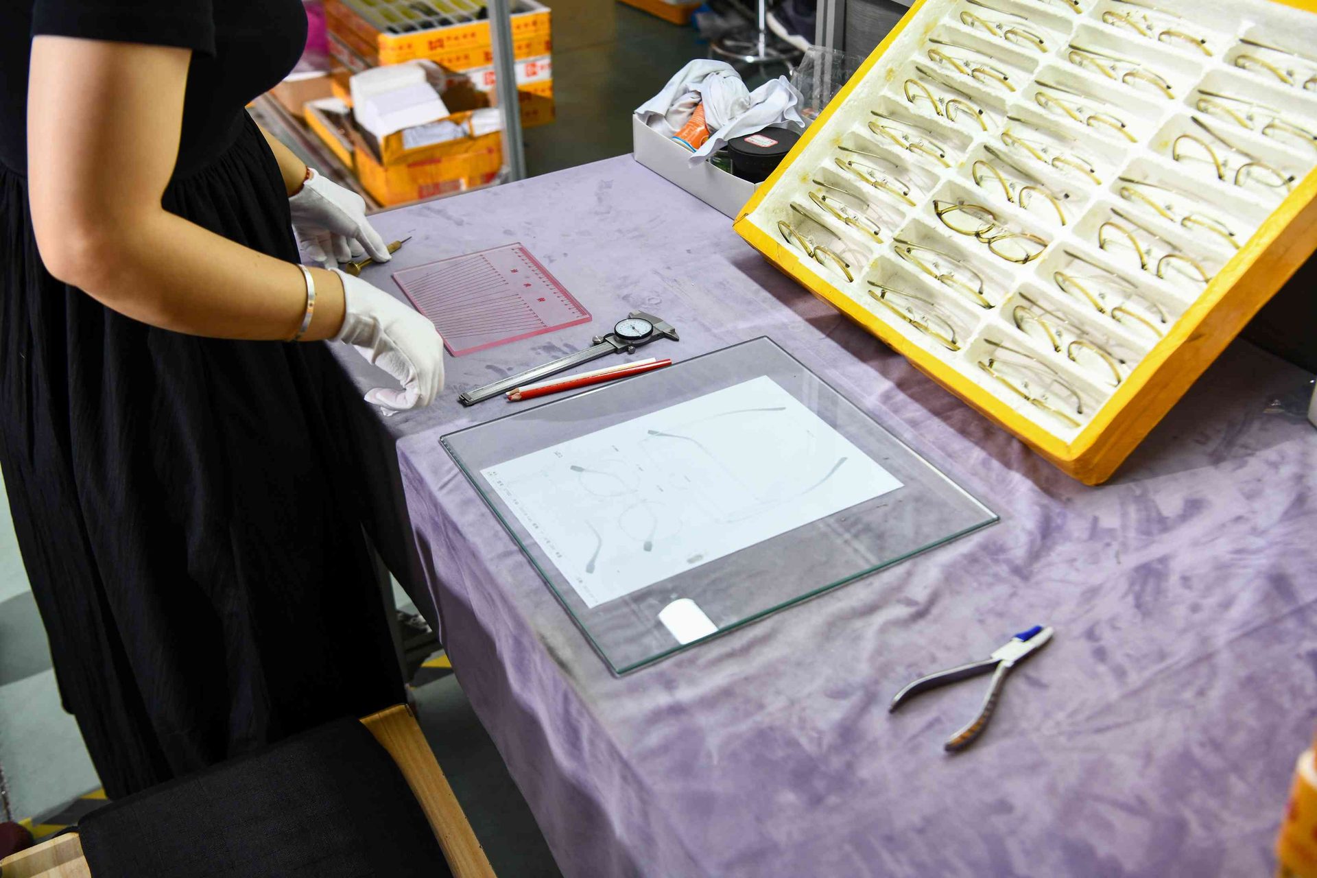 Eyewear quality control station with dial caliper and inspection light table at HAO Eyewear
